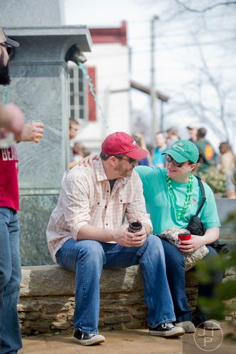 Krisha Wilson (right) puts her arm around her husband Derek during the Roswell Beer Festival & Cornhole Tournament at historic Roswell square on Saturday, March 15, 2014. 
