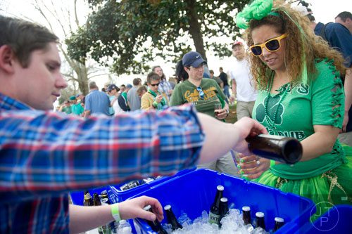 Jessica Campos (right) gets a beer poured by Colin Ryan during the Roswell Beer Festival & Cornhole Tournament at historic Roswell square on Saturday, March 15, 2014. 