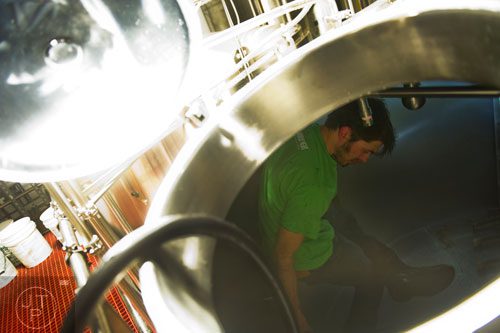 Adam Bishop cleans out a  kettle of beer as he brews at Monday Night Brewing in Atlanta on Thursday, February 20, 2014. 
