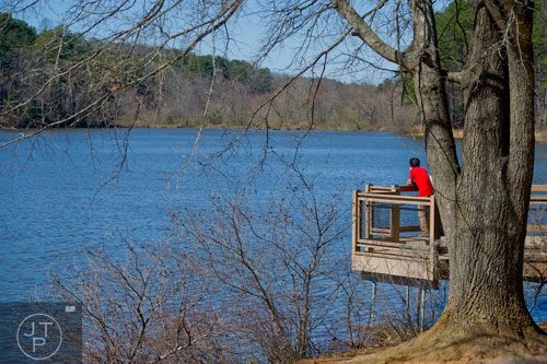 Louis Alonzo looks out over the water at Murphey Candler Park in Brookhaven on Thursday, March 20, 2014.