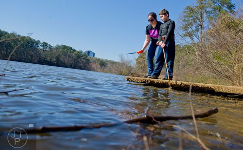 Elisabeth Cortez (left) and her brother Quinn play by the edge of the pond at Murphey Candler Park in Brookhaven on Thursday, March 20, 2014. 