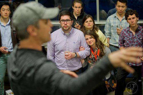 Mitch Muhlheim (center left) and Whitney Kazragis listen to Brian Purcell, owner and brewmaster at Three Taverns Craft Brewery in Decatur, as they take a tour of the facility on Friday, February 21, 2014. 