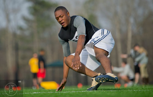 Brandon Morisset reaches down to touch the ground as he  hustles during a pro agility drill during the first tryouts for the new Kennesaw State University football team at The Perch on campus on Saturday, March 22, 2014.