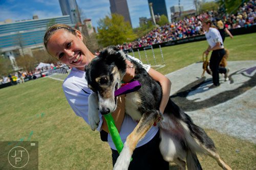 Jamie Herren shows her border collie Zip some love after competing in the 30-Weave-Up-and-Back Competition during the Purina Pro Plan Incredible Dog Challenge at Centennial Olympic Park in Atlanta on Saturday, April 5, 2014. 