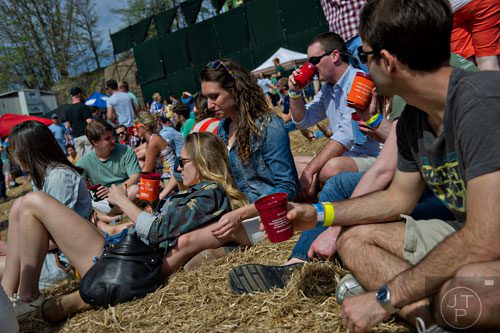 Laura Ellman (left) lays on Rachel Gross as they drink beer during the Hogs and Hops festival at the Masquerade in Atlanta on Saturday, April 5, 2014. 