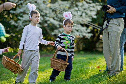 Joshua Black (left) and his brother Caleb carry their baskets as they wait for the start of  the Fernbank Museum of Natural History's Dinosaur Egg Hunt in Atlanta on Saturday, April 12, 2014. 