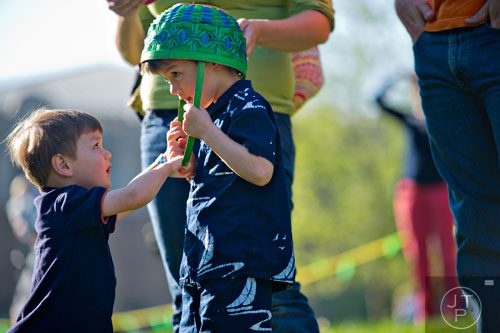 Luke Hardy (left) tries to take his basket off of his brother Logan's head during the Fernbank Museum of Natural History's Dinosaur Egg Hunt in Atlanta on Saturday, April 12, 2014. 