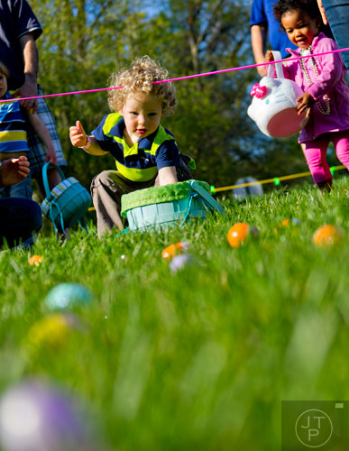 Gavin Ledford tries to get a head start on collecting eggs during the Fernbank Museum of Natural History's Dinosaur Egg Hunt in Atlanta on Saturday, April 12, 2014. 