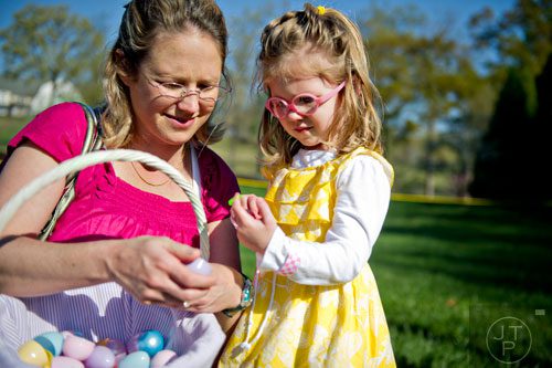 Andi Laird (right) and her mother Carling open eggs during the Fernbank Museum of Natural History's Dinosaur Egg Hunt in Atlanta on Saturday, April 12, 2014. 