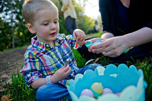 Will Koenig (left) and his mother Kristin open eggs during the Fernbank Museum of Natural History's Dinosaur Egg Hunt in Atlanta on Saturday, April 12, 2014. 