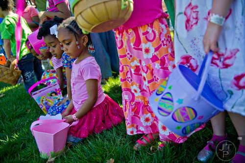 Katie Johnson (center) and London Davidson (left) wait for the start of one of the egg hunts during the Fernbank Museum of Natural History's Dinosaur Egg Hunt in Atlanta on Saturday, April 12, 2014. 