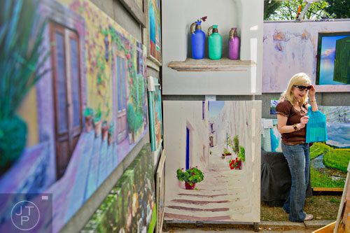 Patti Peach looks at the artwork on display in James Gary Richmond's booth during the 78th Annual Atlanta Dogwood Festival at Piedmont Park on Saturday, April 12, 2014.