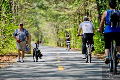 Steve O'Neill (left) walks his dog Murphy down the Silver Comet Trail in Mableton on Saturday, April 12, 2014.  