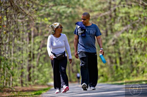 Gwen Marks (left) talks to her husband Alan as they walk down the Silver Comet Trail in Mableton on Saturday, April 12, 2014.  