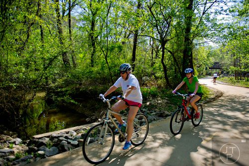 Karen Sillay (left) and her daughter Brooke ride their bikes down the path of the Big Creek Greenway in Alpharetta on Saturday, April 12, 2014. 