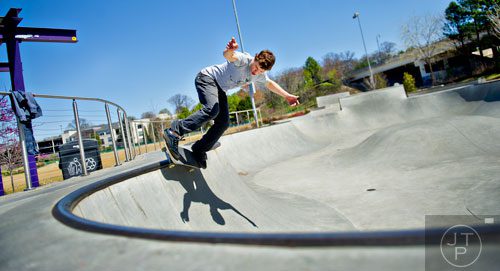 Harley Tolzmann rides his board around the rim of a bowl at the Historic Fourth Ward Skatepark in Atlanta on Wednesday, March 26, 2014.