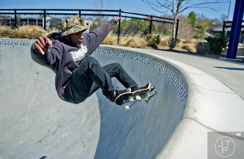 Malik Jones catches some air as he rides his board at the Historic Fourth Ward Skatepark in Atlanta on Wednesday, March 26, 2014. 