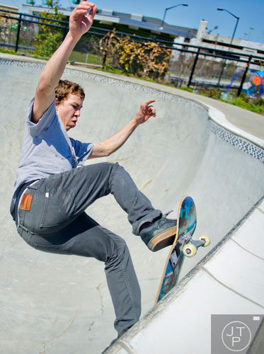 Harley Tolzmann hangs on the rim of a bowl as he rides his board at the Historic Fourth Ward Skatepark in Atlanta on Wednesday, March 26, 2014. 