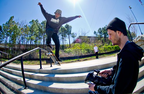 Eric Clavel (right) uses a camera to film his friend Malik Jones as he slides down a rail on his board at the Historic Fourth Ward Skatepark in Atlanta on Wednesday, March 26, 2014. 