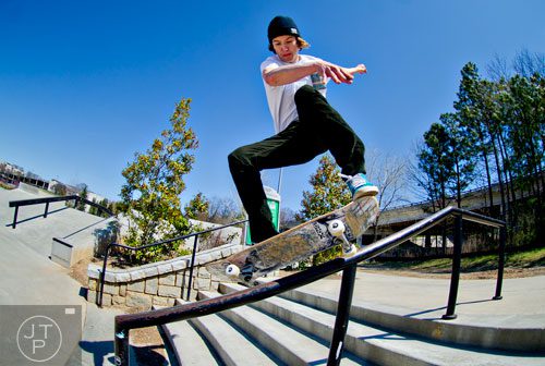Ryan Wood slides down a rail as he rides his board at the Historic Fourth Ward Skatepark in Atlanta on Wednesday, March 26, 2014. 