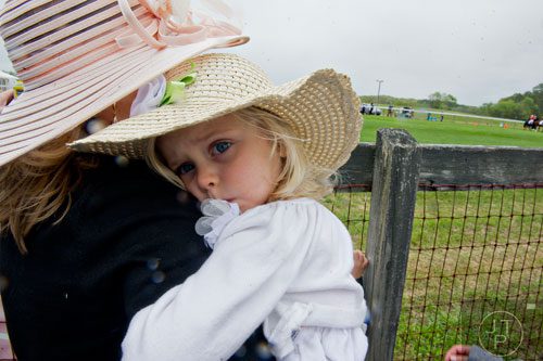 Audrey Stubblefield (right) nuzzles against her mother Whitney as they watch the races during the 49th Annual Running of the Atlanta Steeplechase At Kingston Downs in Rome on Saturday, April 19, 2014. 