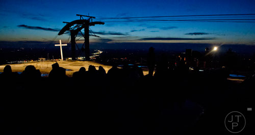 The sun rises as people gather on top of Stone Mountain before the start of the 70th annual Easter Sunrise Service on Sunday, April 20, 2014. 