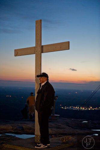 Dave Fernandez has his photo taken by the cross on top of Stone Mountain before the start of the 70th annual Easter Sunrise Service on Sunday, April 20, 2014.