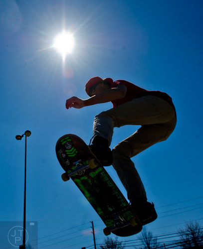 Brandon Spoiala flies through the air at Duncan Creek Skatepark in Dacula as he rides his skateboard on Thursday, March 27, 2014.