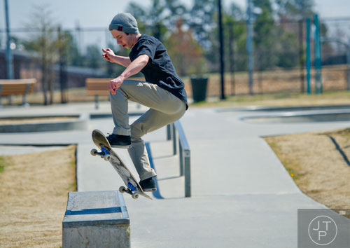 Brandon Benifield flies through the air as he attempts to land on a raill at Duncan Creek Skatepark in Dacula as he rides his skateboard on Thursday, March 27, 2014. 