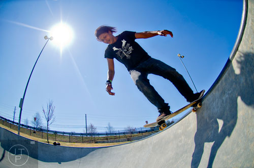 T.J. Shubert-Helton drops into a bowl at Duncan Creek Skatepark in Dacula as he rides his skateboard on Thursday, March 27, 2014. 