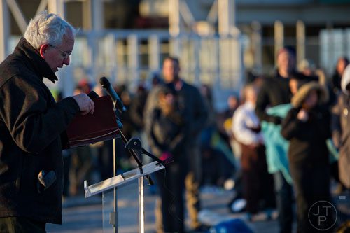 Dr. Larry Burgess (left) reads the gospel at the top of Stone Mountain during the 70th annual Easter Sunrise Service on Sunday, April 20, 2014. 