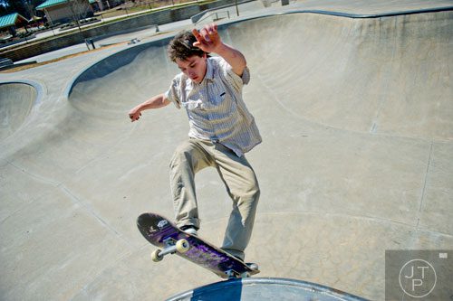 David Lamb rides his skateboard in one of the bowls at the Settles Bridge Skatepark in Suwanee on Thursday, March 27, 2014.   