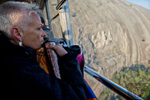 Nancy Botts looks out of the window of the skylift as she rides down from the top of Stone Mountain after the 70th annual Easter Sunrise Service on Sunday, April 20, 2014. 