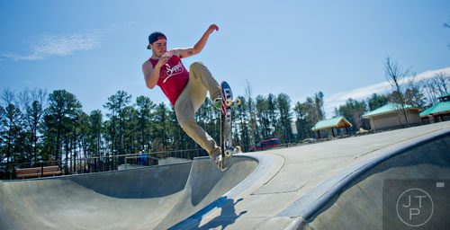 Michael Jewell catches some air as he rides his skateboard at the Settles Bridge Skatepark in Suwanee on Thursday, March 27, 2014.  