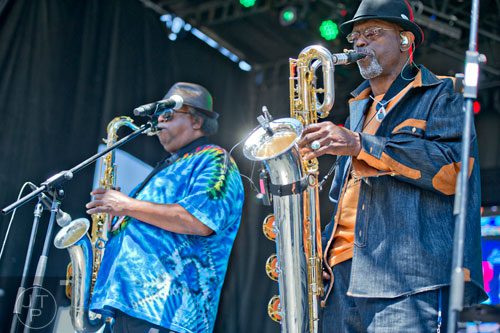 Roger Lewis (right) and Kevin Harris play their saxophones as they perform with other members of the Dirty Dozen Brass Band on stage during the Sweetwater 420 Festival at Centennial Olympic Park on Sunday, April 20, 2014.