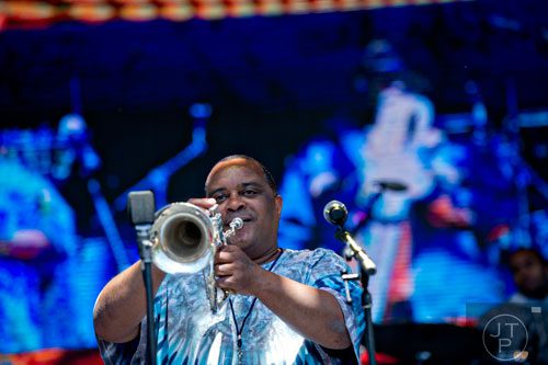 Efrem Towns plays his trumpet as he performs with other members of the Dirty Dozen Brass Band on stage during the Sweetwater 420 Festival at Centennial Olympic Park on Sunday, April 20, 2014. 