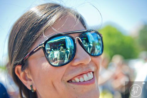 The main stage is reflected in Johanna Isler's sunglasses as the Dirty Dozen Brass Band performs on stage during the Sweetwater 420 Festival at Centennial Olympic Park on Sunday, April 20, 2014.