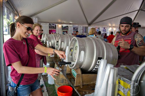 Tanya Morea (left) pours John Hurd a beer during the Sweetwater 420 Festival at Centennial Olympic Park on Sunday, April 20, 2014. 