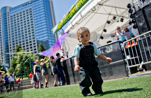 One-year-old Rocky Minton (center) dances during the Sweetwater 420 Festival at Centennial Olympic Park on Sunday, April 20, 2014. 