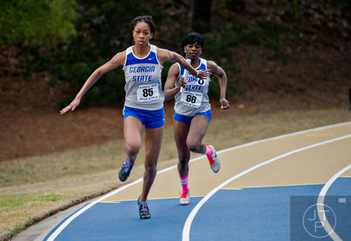 Georgia State's Wande Brewer (85) is handed the stick by Gabby Brooks in the 4x100 Meter Relay during the Yellow Jacket Invitational track meet on Saturday, March 29, 2014.
