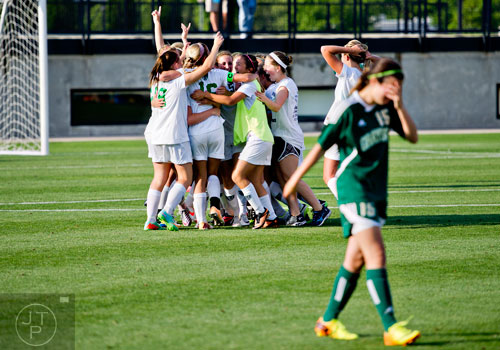 Harrison players celebrate their 2-1 victory over Grayson at the conclusion of the Class AAAAAA championship soccer game at Kennesaw State University on Saturday, May 17, 2014. 