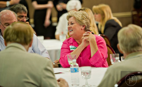 Dianne Fries (center) laughs as she mingles during Karen Handel's election party at the Double Tree Hotel in Roswell on Tuesday, May 20, 2014.