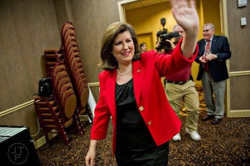 Karen Handel (center) waves to friends and supporters during her election party at the Double Tree Hotel in Roswell on Tuesday, May 20, 2014. 