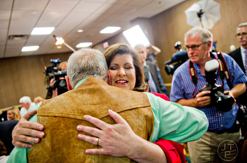 Karen Handel (center) hugs Fred Stephenson as she greets friends and supporters during her election party at the Double Tree Hotel in Roswell on Tuesday, May 20, 2014. 