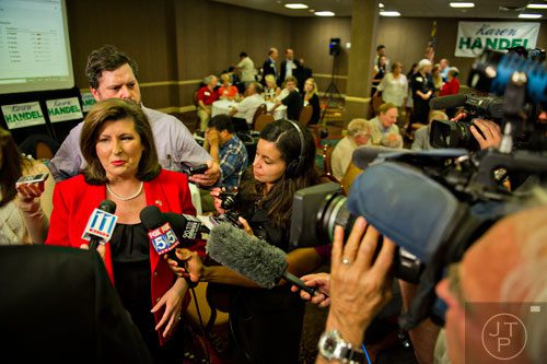 Karen Handel (left) speaks to numerous members of the media during her election party at the Double Tree Hotel in Roswell on Tuesday, May 20, 2014. 