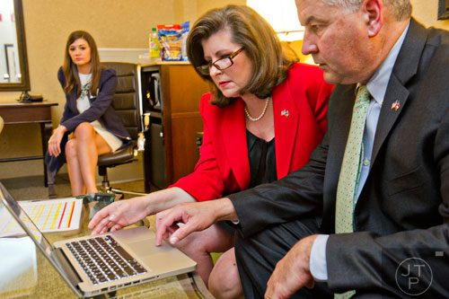 Karen Handel (center) and her husband Steve look at polling data during Karen's election party at the Double Tree Hotel in Roswell on Tuesday, May 20, 2014. 