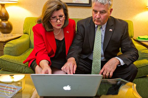 Karen Handel (left) and her husband Steve look at polling data during Karen's election party at the Double Tree Hotel in Roswell on Tuesday, May 20, 2014. 