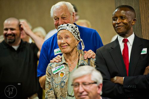 Ingrid Moggre (center), Bob Weyand and Francis Kungu watch Karen Handel take the stage during her election party at the Double Tree Hotel in Roswell on Tuesday, May 20, 2014. 