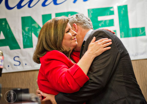 Karen Handel (left) is hugged by her husband Steve after missing out on a runoff position for the U.S. Senate at the Double Tree Hotel in Roswell on Tuesday, May 20, 2014.    