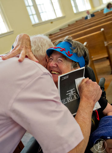 Betty Thompson (right) gives Mark Reeve a hug before worship service at Oakhurst Baptist Church in Decatur on Sunday, May 25, 2014.